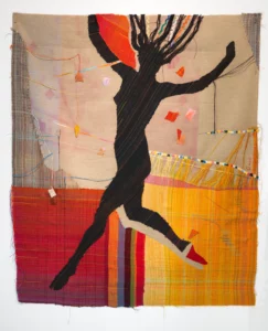 woven tapestry of a naked woman jumping with her hair flying in the wind, silhouetted against a background of colorful with red and yellow boxes of color